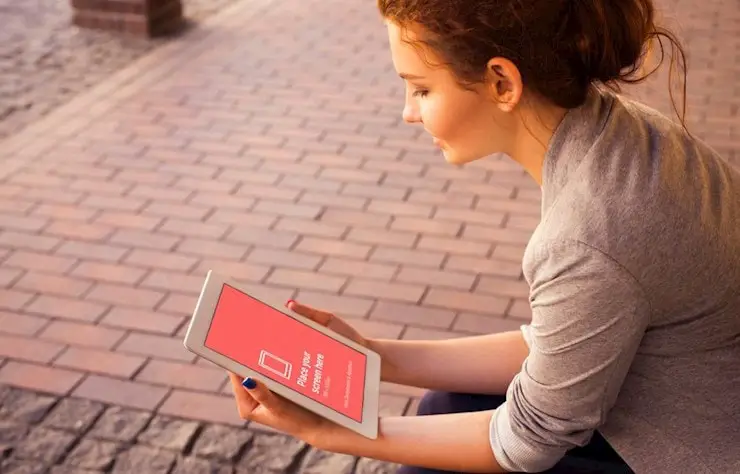 young-woman-looking-at-ipad-free-mockup-1000x640